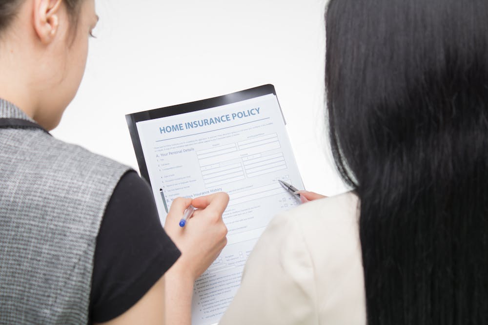 women holding a home insurance form or policy
